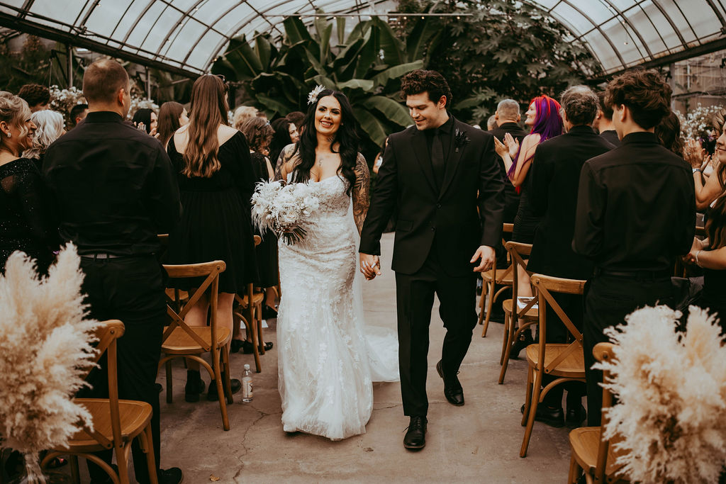 the wedding couple walking down the aisle together in Calgary